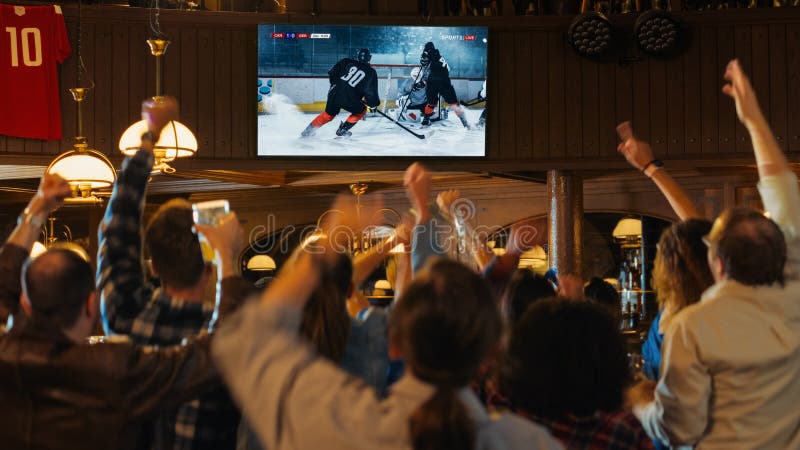 Group of Friends Watching a Live Ice Hockey Match on TV in a ...